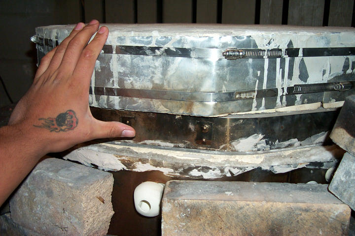 Two lids together on kiln (hand for scale)